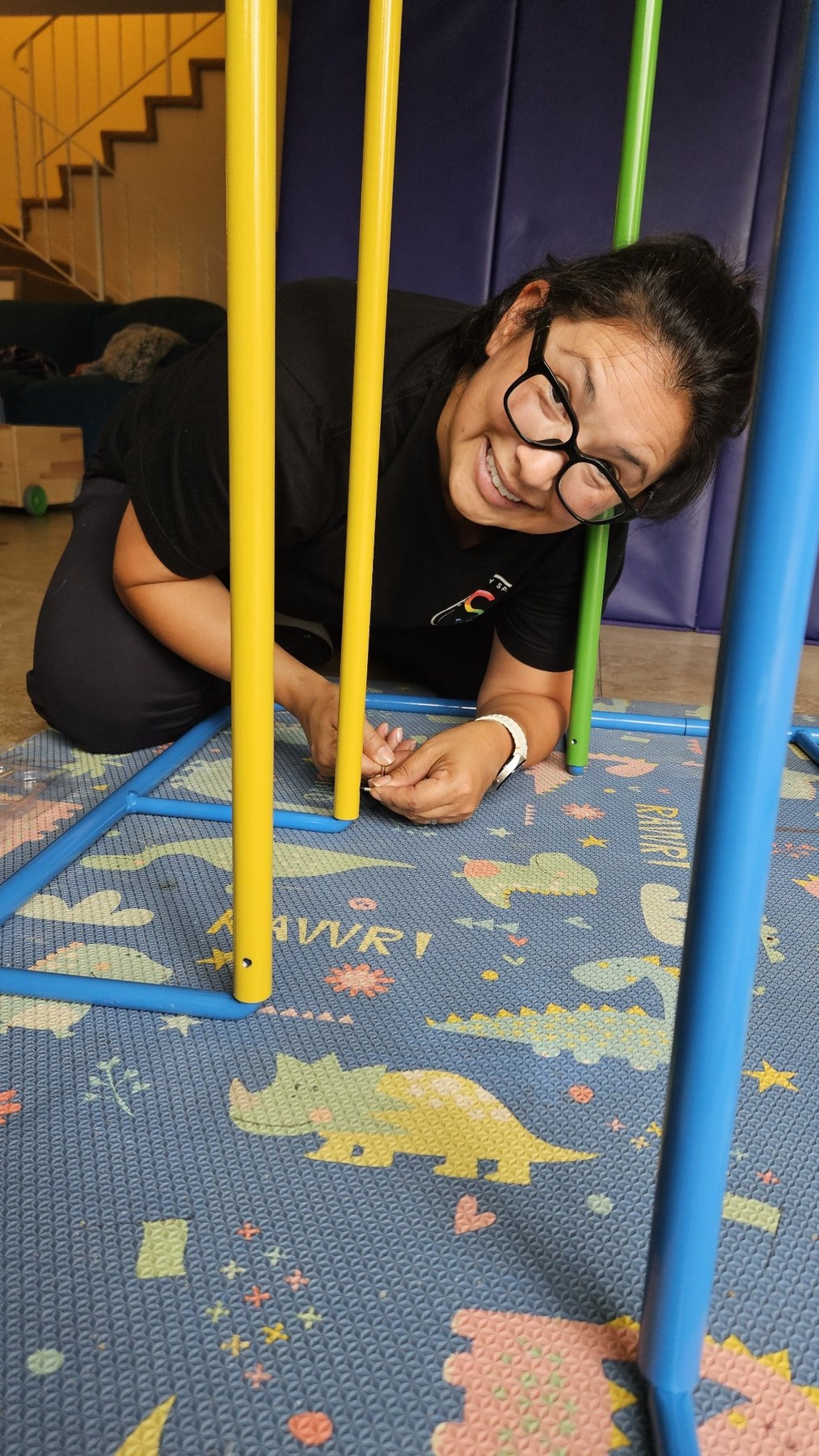 Olivia Martinez-Hauge fastening part of a custom sensory structure during installation.